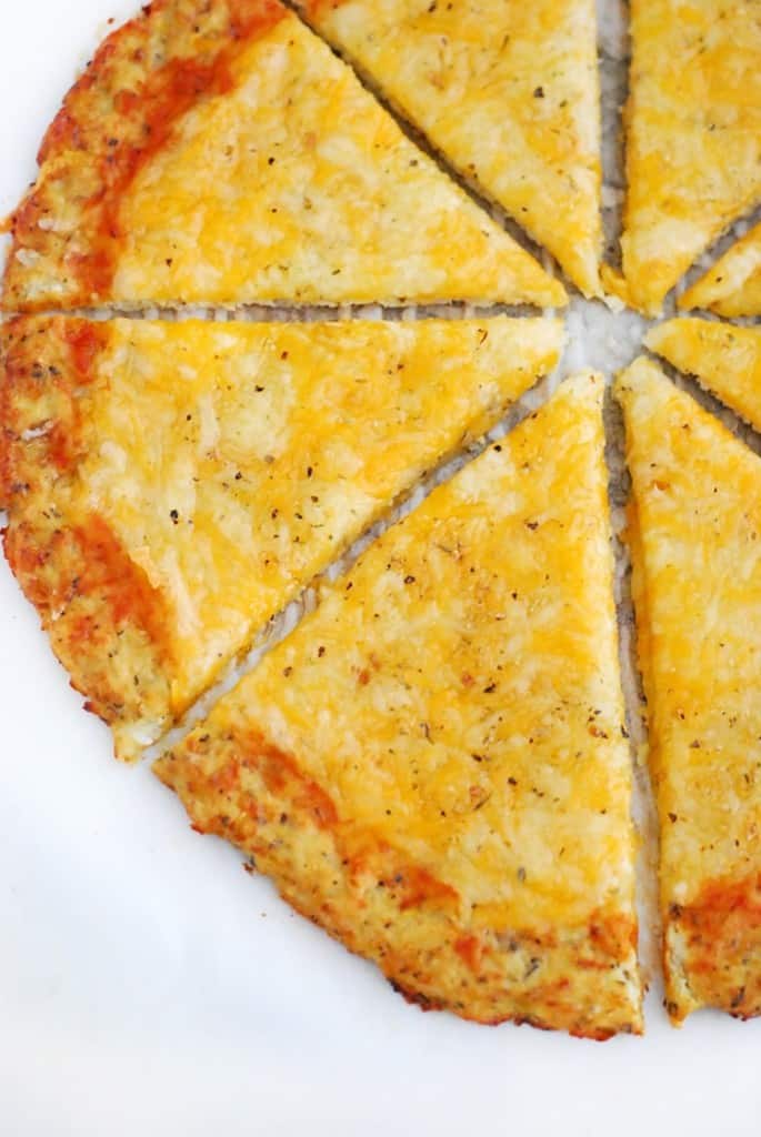 Low Carb Cauliflower Pizza Crust - no need to go for the carb loaded frozen pizza when you can whip this tasty cauliflower pizza crust up in under an hour. 