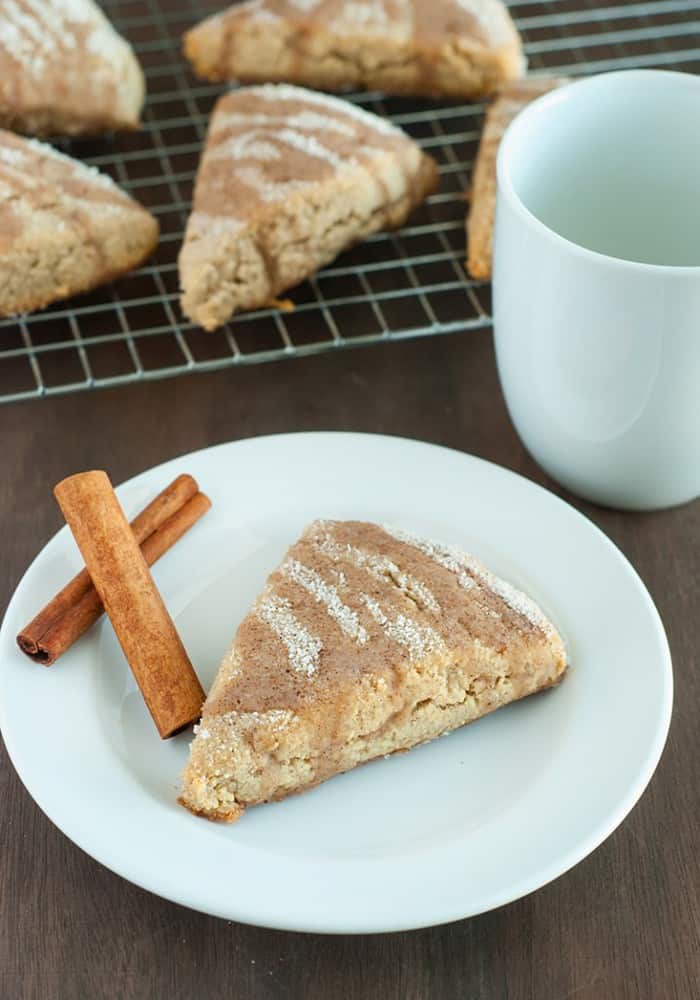 Cinnamon Scones - tender and flaky cinnamon scones powdered in sweet cinnamon and drizzled with a vanilla glaze.
