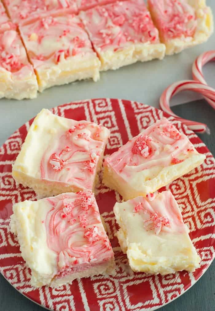 Peppermint Cheesecake Bars - velvety goodness with crunchy bits of candy cane on top. This is the ULTIMATE holiday favorite in my household!