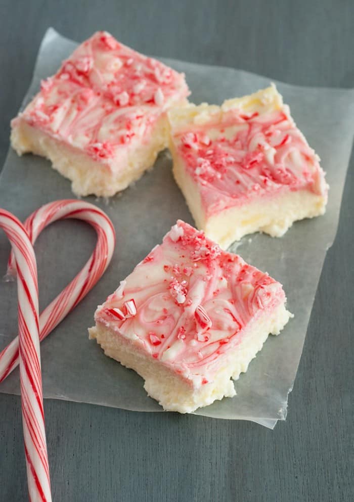 Velvety Peppermint Cheesecake Bars with crunchy bits of candy cane on top. A holiday favorite dessert!